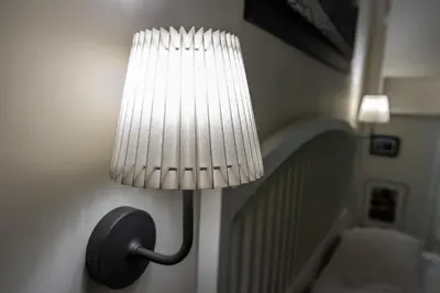 a lamp on a wall with a light on it at B&B Saint Paul in Rome
