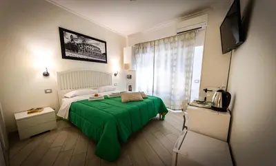 a bedroom with a green bed and a television at B&B Saint Paul in Rome