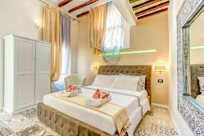 a bedroom with a large bed with shoes on it at Hub Pantheon in Rome