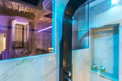 a bathroom with a shower with a sink and a mirror at Hub Pantheon in Rome