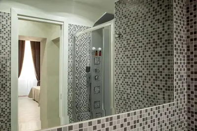 a bathroom with a mirror and a shower at Frattina Grand Suite Guesthouse in Rome