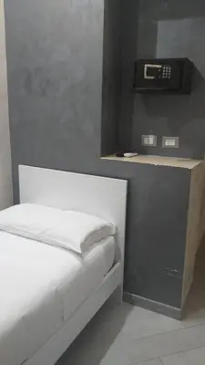 a bedroom with a bed with a scale on a shelf at Frattina Grand Suite Guesthouse in Rome