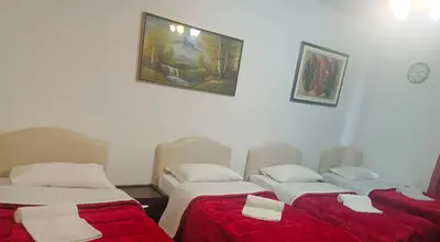 a room with three beds with red sheets at Host Roma in Rome
