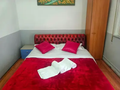 a bed with two red pillows and two white socks at Host Roma in Rome