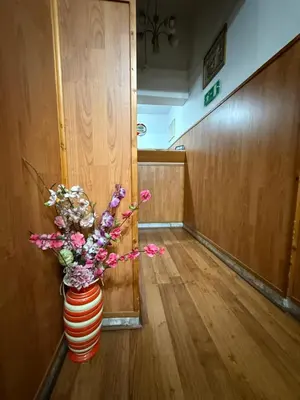 a vase of flowers sitting in a hallway at Host Roma in Rome