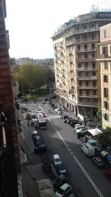 a city street with cars parked in a parking lot at Room 14 in Rome