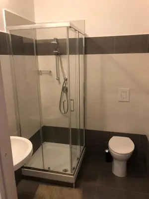 a bathroom with a shower and a toilet and a sink at Room 14 in Rome