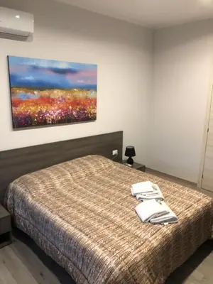 a bedroom with a bed with two towels on it at Room 14 in Rome