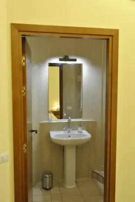 a bathroom with a sink and a mirror at Roma Tourist House in Rome