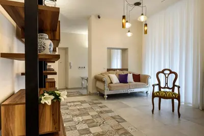 a living room with a couch and a chair at Navona Luxury Guesthouse in Rome