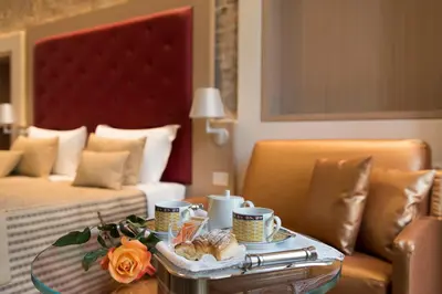 a hotel room with a table with coffee cups and pastries at Navona Luxury Guesthouse in Rome