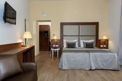 a hotel room with a bed and a television at Navona Luxury Guesthouse in Rome