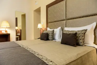 a bedroom with a large bed with a large headboard at Navona Luxury Guesthouse in Rome