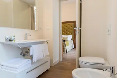 a bathroom with a sink and a toilet at Navona Luxury Guesthouse in Rome