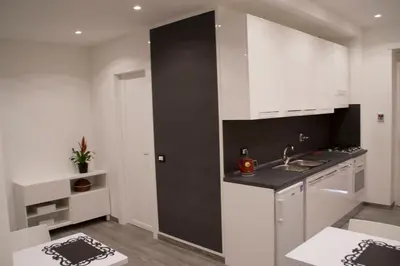 a kitchen with white cabinets and a sink at DaNoi in Trastevere in Rome