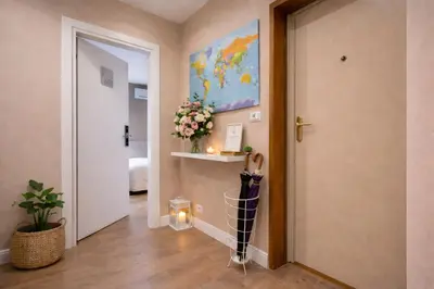 a hallway with a door and a painting on the wall at Tollì rooms in Rome