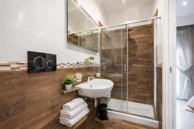 a bathroom with a sink and a shower at Tollì rooms in Rome