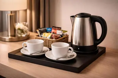 a tray with two cups and a coffee pot on a table at Tollì rooms in Rome
