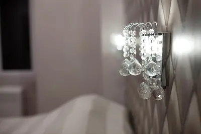a cluster of wine glasses hanging on a wall at Maison Imperiale in Rome