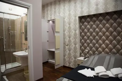 a bathroom with a bed and a sink and a shower at Maison Imperiale in Rome
