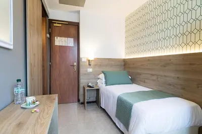 a hotel room with a bed and a table at Hotel Pacific in Rome