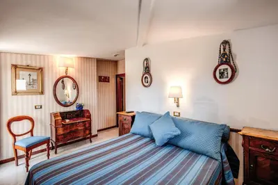 a bedroom with a blue bed and a desk at Hotel Pacific in Rome