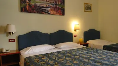 a hotel room with two beds and a painting on the wall at Hotel Altavilla Dieci in Rome