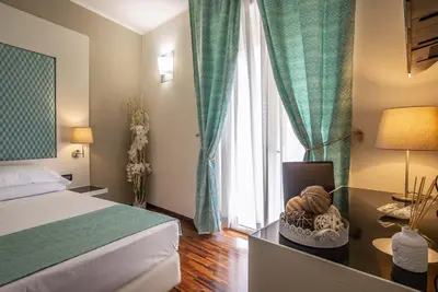 a bedroom with a bed and a table with a basket of balls at Merulana Inn Guest House in Rome