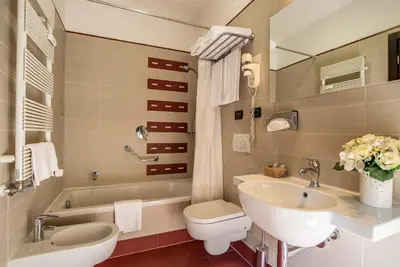 a bedroom with a bed and a large window at Merulana Inn Guest House in Rome