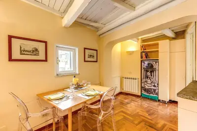 a dining room with a table and chairs at Trastevere Attic with Terrace in Rome