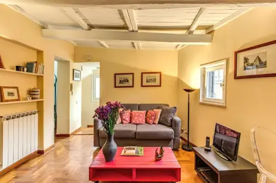 a living room with a couch and a table at Trastevere Attic with Terrace in Rome