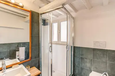 a bathroom with a shower and a sink at Trastevere Attic with Terrace in Rome