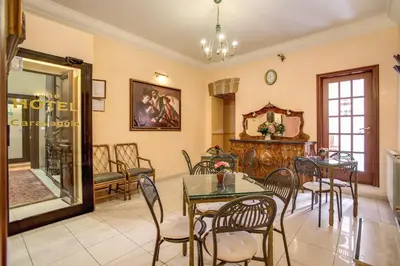 a dining room with a table and chairs at Hotel Caravaggio in Rome