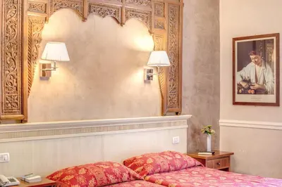 a hotel room with a bed and a picture on the wall at Hotel Caravaggio in Rome
