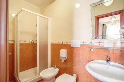 a bathroom with a toilet and a sink and a shower at Hotel Caravaggio in Rome