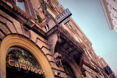 a building with a sign on the side of it at Hotel Caravaggio in Rome