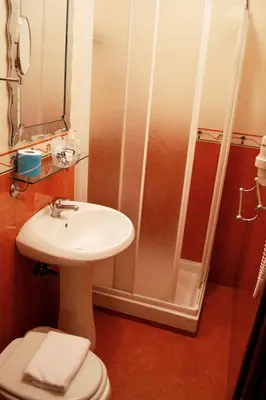 a bathroom with a shower and a sink and a toilet at Hotel Caravaggio in Rome