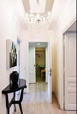 a dining room with a table and a chandelier at Vatican View Apartment in Rome