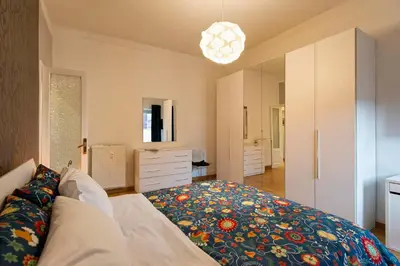 a bedroom with a large bed and a large mirror at Rome La Sapienza Apartment in Rome