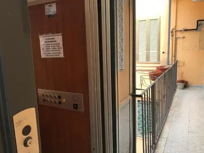 a door with a sign on it next to a balcony at Rome La Sapienza Apartment in Rome