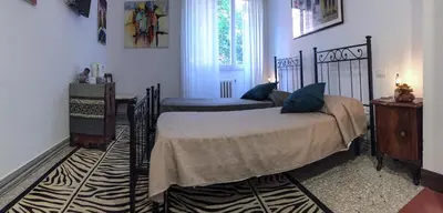 a bedroom with two beds and a window at Bausan 12 in Rome