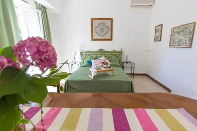 a bedroom with a bed and a table and flowers at Bausan 12 in Rome