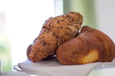 three loaves of bread sitting on top of a plate at Bausan 12 in Rome