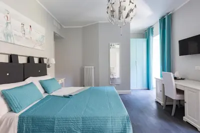 a bedroom with a large bed with a desk and a computer at Residenza Vatican Suite in Rome