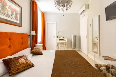 a bedroom with a bed with two pillows on it at Residenza Vatican Suite in Rome