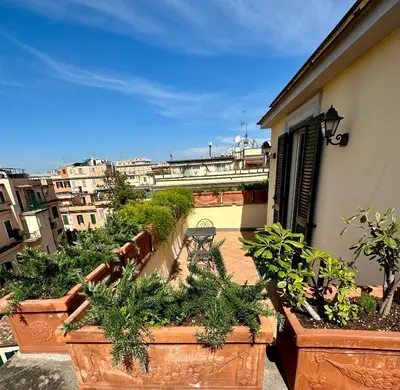 a balcony with potted plants on the side of a building at Hotel Principe Di Piemonte in Rome