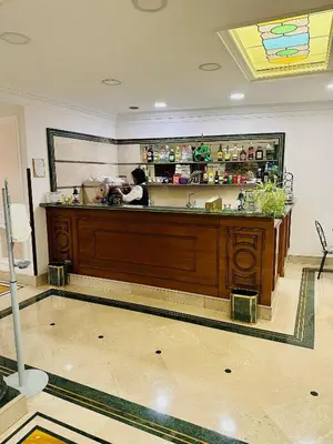a woman standing behind a counter in a kitchen at Hotel Principe Di Piemonte in Rome