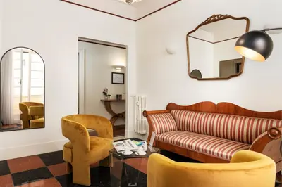 a living room with a couch and a chair at Gatsby Guest House - Zen 60 in Rome