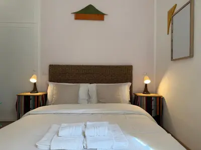 a bedroom with a bed with two towels on it at Green Rooms Trastevere in Rome