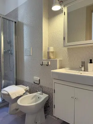 a bathroom with a toilet and a sink and a shower at Green Rooms Trastevere in Rome